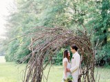 a cool bent wedding arch of only branches is a bold natural statement, totally out of the box