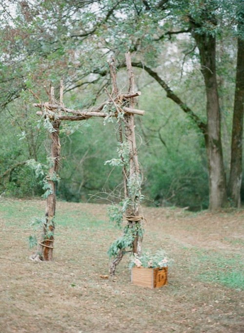 a woodland wedding arch of branches and twigs, with some leaves is a simple idea to realize yourself