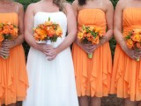 orange strapless A-line bridesmaid dresses with ruffles and draped bodices and orange wedding bouquets are amazing