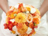 a round orange and white wedding bouquet can be a nice idea for an orange beach wedding
