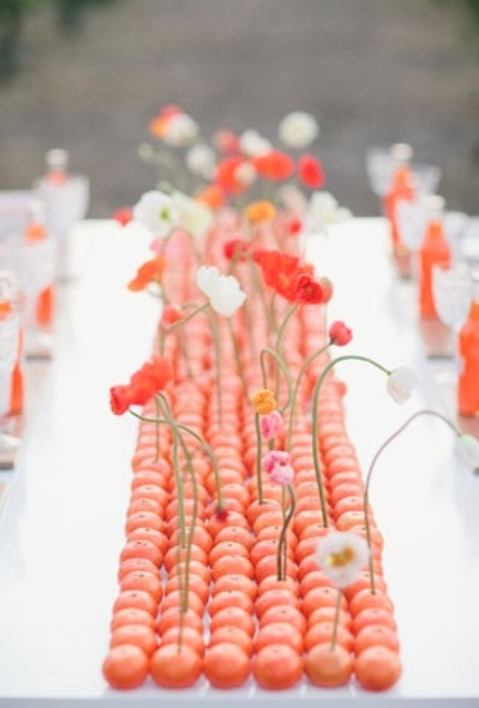 a unique beach wedding centerpiece of citrus and bright and white blooms is a great idea for a tropical beach wedding