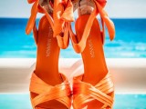 gorgeous orange back bow shoes are amazing for an orange beach wedding, it’s a bold touch of color to a bridal look
