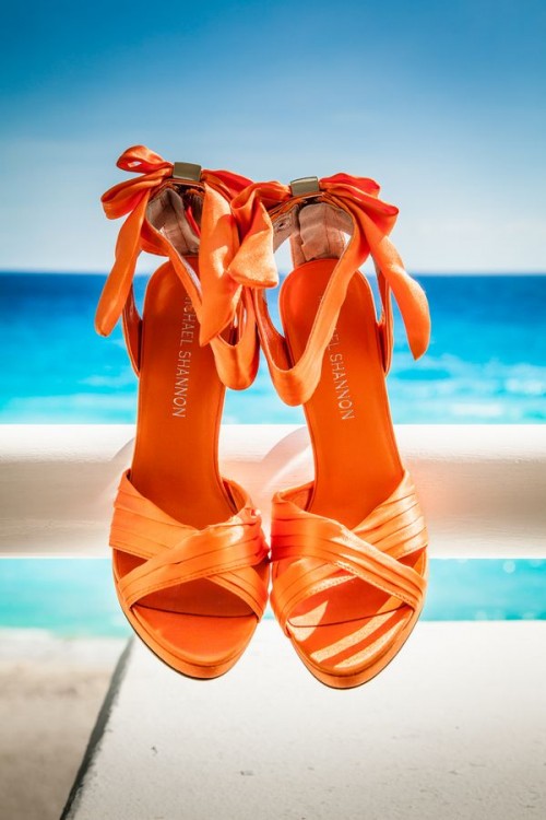 gorgeous orange back bow shoes are amazing for an orange beach wedding, it's a bold touch of color to a bridal look