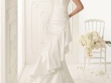 a beautiful romantic one shoulder wedding dress with a draped bodice, a ruffle line and a train is a lovely idea for a vintage-inspired bridal look