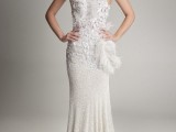 a whimsical one shoulder wedding dress, a fully embellished gown with a lace, rhinestone and feather detailed bodice and a small train