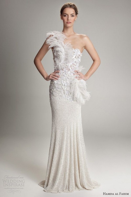 a whimsical one shoulder wedding dress, a fully embellished gown with a lace, rhinestone and feather detailed bodice and a small train