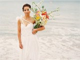 a one shoulder A-line wedding dress with ribbons, a tulle skirt is a lovely idea for a beach wedding