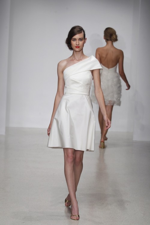 a modern take on a 50s wedding dress - a plain A-line knee dress with a shoulder detail and a draped bodice