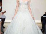 a modern floral wedding ballgown with a sweetheart neckline and a shoulder detail and a veil
