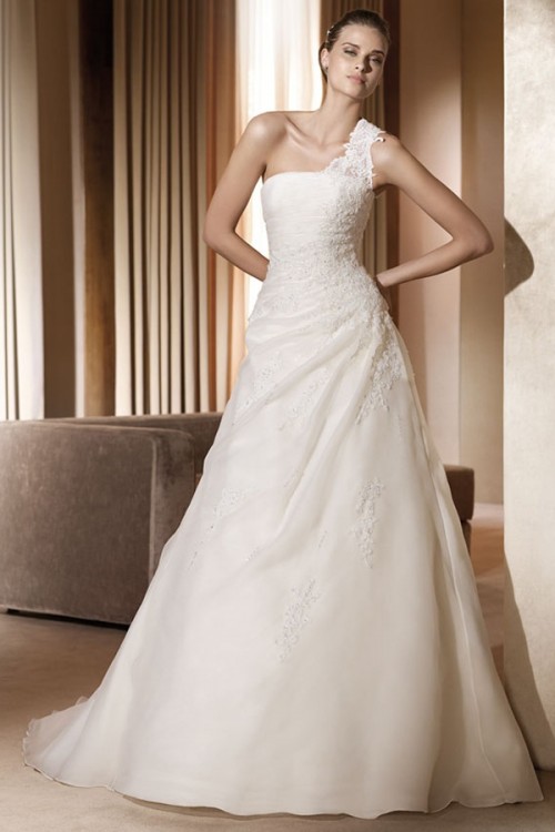 an exquisite lace wedding ballgown with a one shoulder detail, a slight pleated detail on the skirt and a train
