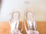 silver wedding shoes with lavender-colored fabric flowers on top are perfect for a summer garden bride