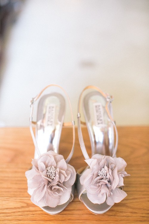 silver wedding shoes with lavender-colored fabric flowers on top are perfect for a summer garden bride