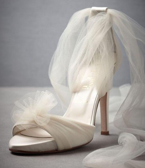 white fabric high heels with a tulle bloom and tulle straps will give an ethereal touch to your bridal look