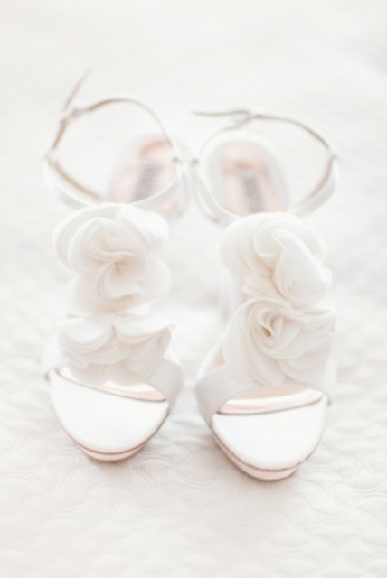 airy white heeled sandals with straps and white fabric blooms look ethereal and very romantic