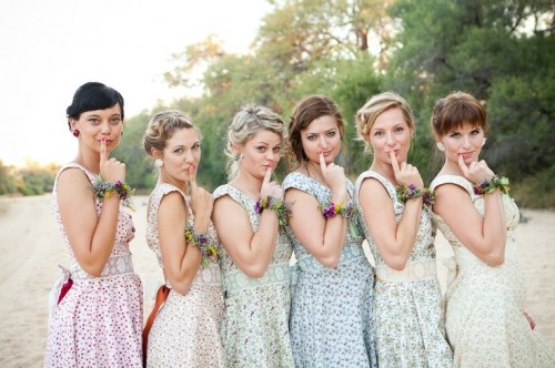 pastel floral vintage bridesmaid dresses with thick straps are a great idea for a vintage or retro wedding, floral bracelets and chic hairstyles finish off the looks