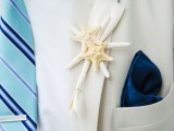 a creamy suit, a bold blue striped tie, a navy handkerchief and a starfish boutonniere for a more formal look