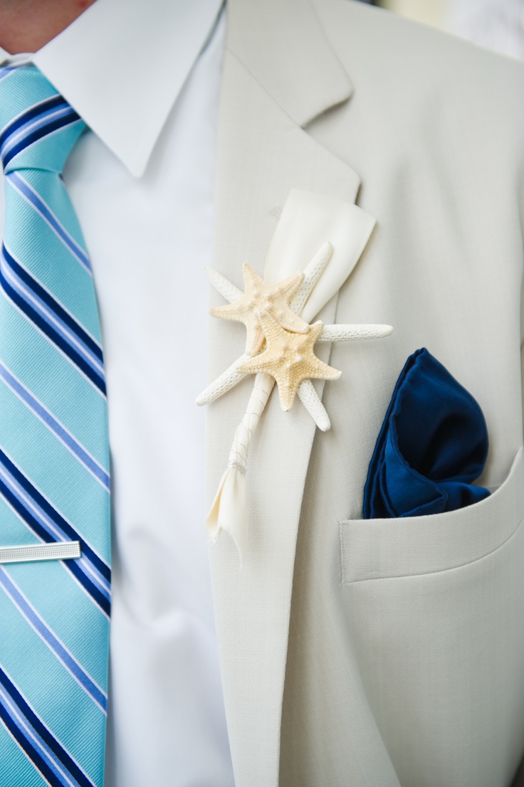 a creamy suit, a bold blue striped tie, a navy handkerchief and a starfish boutonniere for a more formal look