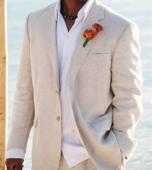 a tan linen suit, a white shirt, a bright floral boutonniere for a not too formal look