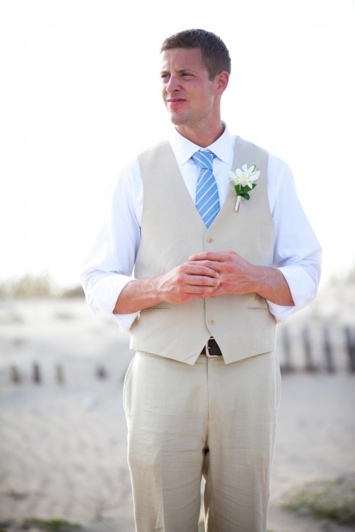 a neutral suit with a waistcoat, a white shirt and a blue striped tie is a nice combo for a beach groom