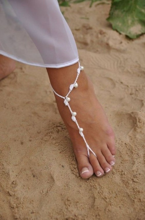 simple white thread and pearl barefoot beach wedding sandals are a slight accent to your beach bridal look
