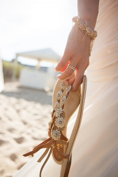 flat beach sandals decorated with fabric flowers are a nice solution for a beach bride