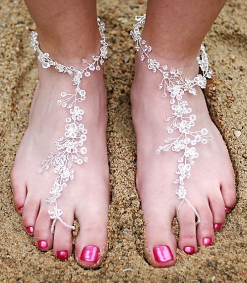 fully embellished barefoot beach wedding sandals with floral patterns look veyr chic and very cool
