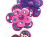 colorful felt flower-shaped ornaments with bold sequins and buttons are amazing to style your wedding, for various decorations and centerpieces
