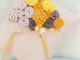 a ring pillow with bold yellow and grey felt floral decor is a lovely idea for a bright and contrasting wedding