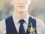 a chic groom’s look with a grey button down, a navy tie and waistcoat plus a floral boutonniere