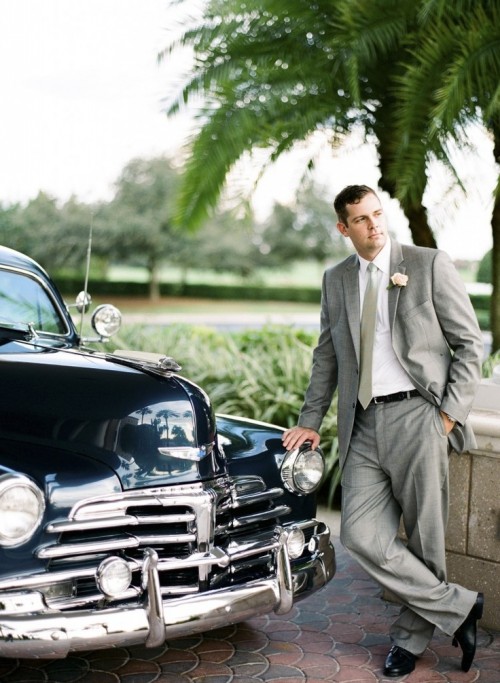 a vintage-inspired groom's outfit with a grey suit and tie, a white shirt and black shoes