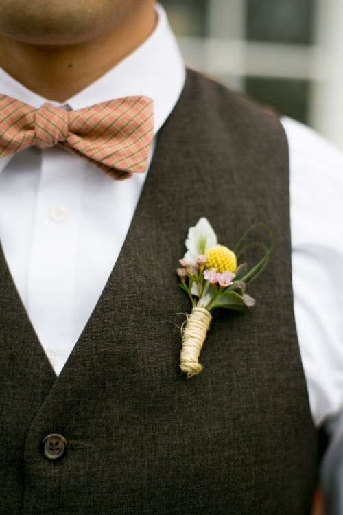 a stylish groom's look with a white button down, a chocolate brown waistcoat and a rust bow tie plus a floral boutonniere