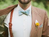 a vintage outfit with a rust striped suit, a blue printed bow tie and rust woven suspenders