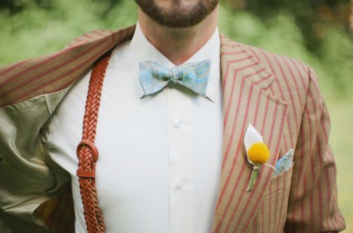 a vintage outfit with a rust striped suit, a blue printed bow tie and rust woven suspenders