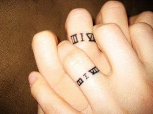 wedding date tattoos with Roman numbers done as wedding bands is a cool and bold idea