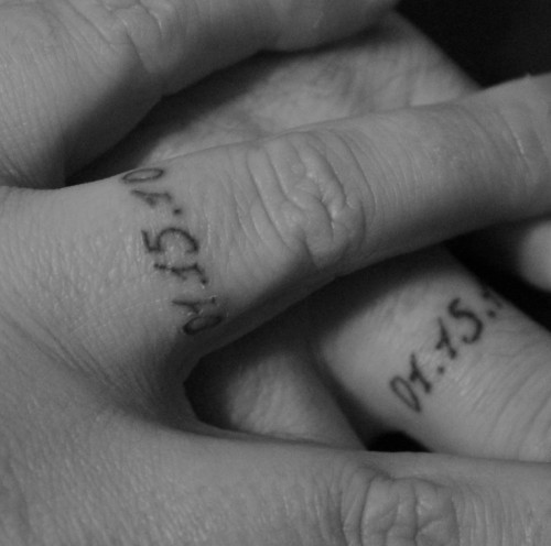 simple black ink wedding date tattoos with usual numbers instead of usual wedding bands