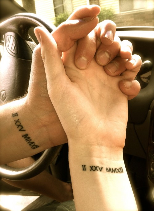 wedding date tattoos done with Roman numbers and placed on the wrists for a cool look