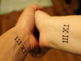 matching wedding date tattoos done with Roman numbers and placed on the wrists