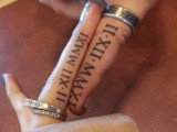 usual wedding bands paired with wedding date tattoos done with roman numbers on the sides of the fingers
