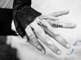 a stylish wedding date tattoo done with Roman figures and monograms on the ring fingers