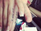 wedding date tattoos made with Roman numbers on the sides of the ring fingers