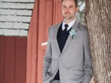 a grey suit, a black jumper over the shirt, a black tie and a white button down for an elegant and chic winter groom’s look