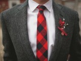 a grey tweed suit, a white button down, a red checked tie and a red boutonniere to add color to the look