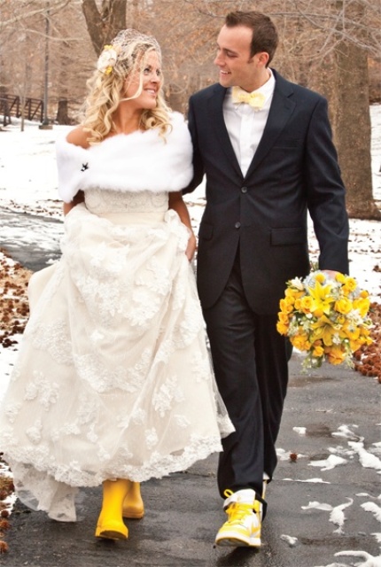 a black suit, a white button down, a yellow bow tie and matching boots for a bright and fun winter groom's look