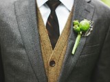 a grey suit, a tan cardigna, a white button down and a burgundy striped tie