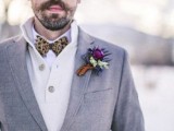 a grey tweed suit, a creamy cardigan, a white button down, an animal print bow tie plus a bright boutonniere