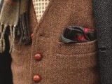 a printed shirt and tie, a brown tweed waistcoat, a grey tweed blazer plus a scarf for a catchy look