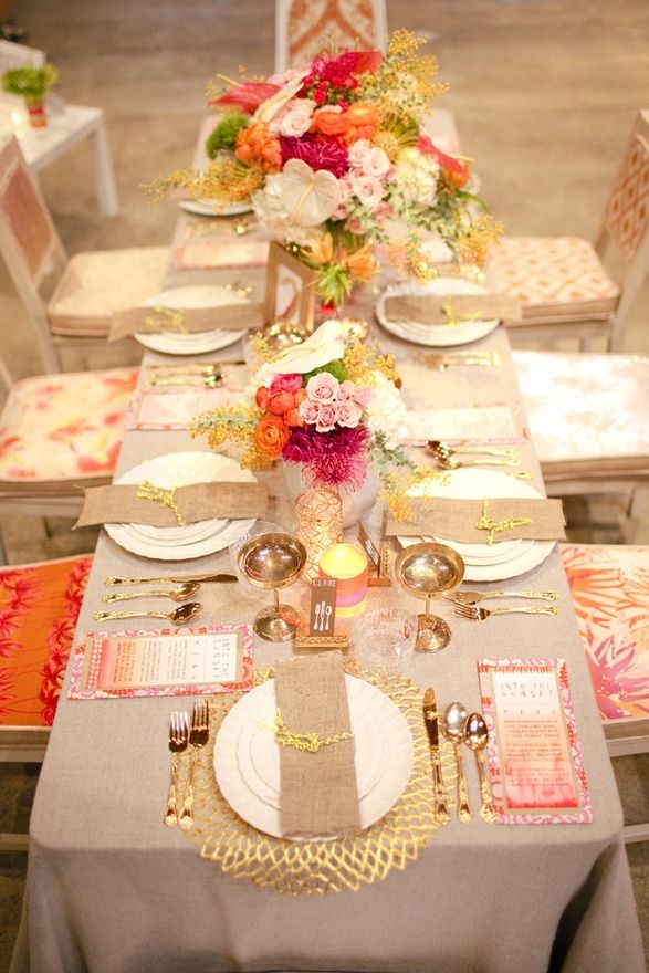 A bright and glam fall bridal shower tablescape done with bold floral arrangements, gold touches, colorful menus and burlap napkins
