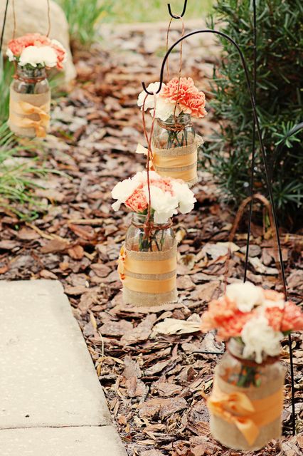 fall bridal shower or wedding decor with mason jars wrapped with burlap and bright fall blooms