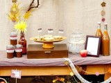 a fall bridal shower bar or station with fall drinks, tarts and apples plus apple, bloom and foliage decor