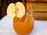 apple cider topped with a slice of fresh apple is a cool signature drink for your bridal shower
